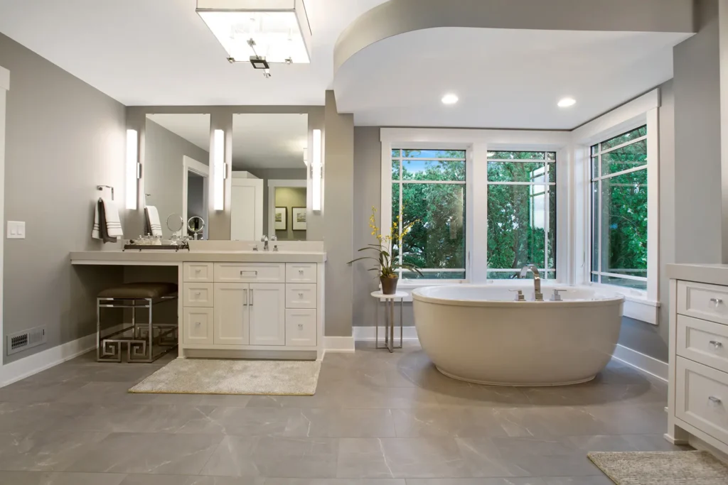 Bathtub surrounded by windows and luxury features inside