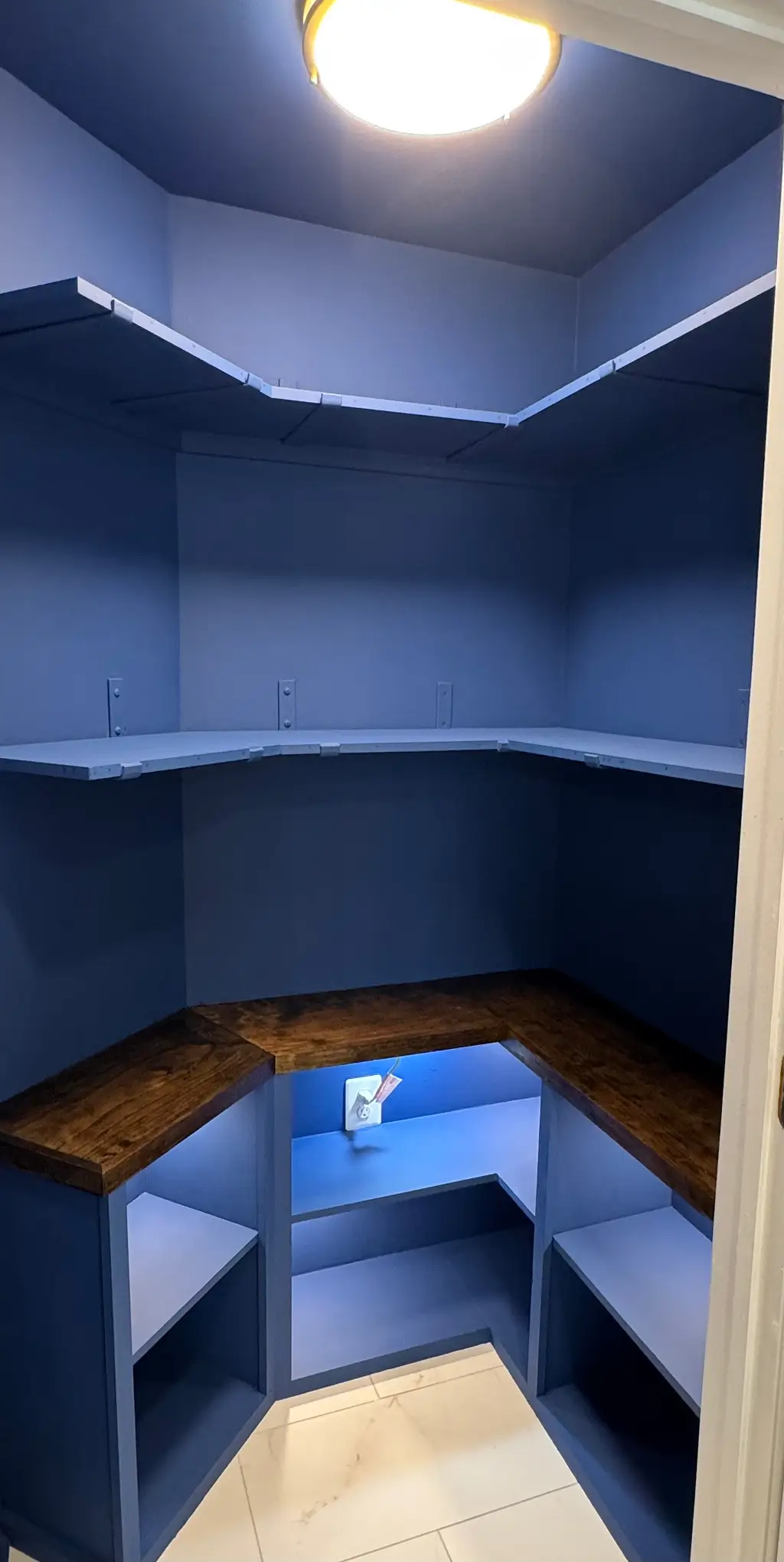 Custom built-in pantry with wood shelving after home remodeling by JBL Construct