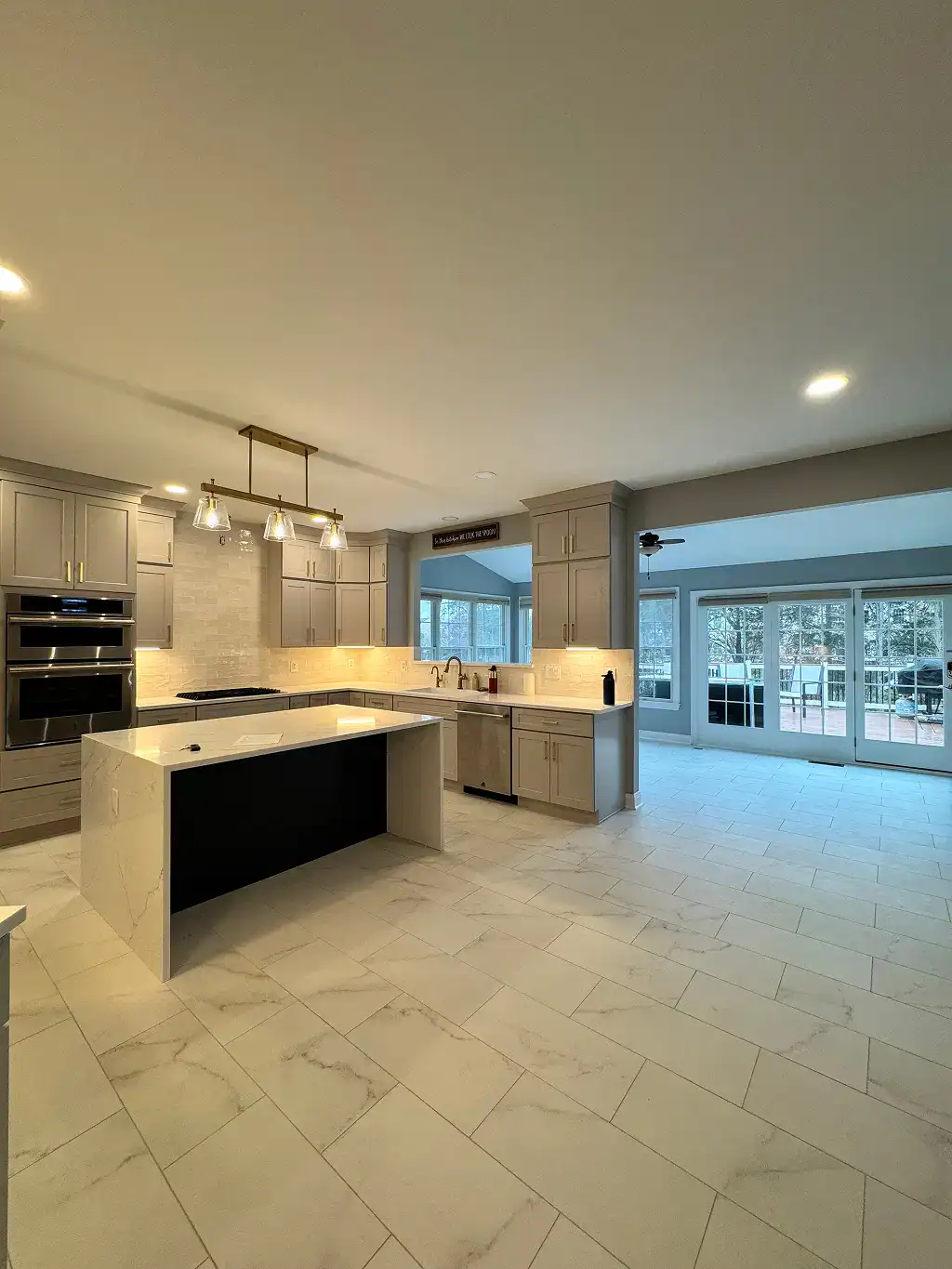Modern kitchen remodel by JBL Construct in Northern Virginia — white cabinetry and quartz island