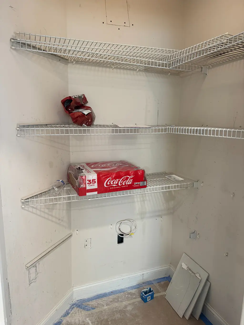 Outdated pantry with wire shelving prior to home remodeling in Northern Virginia