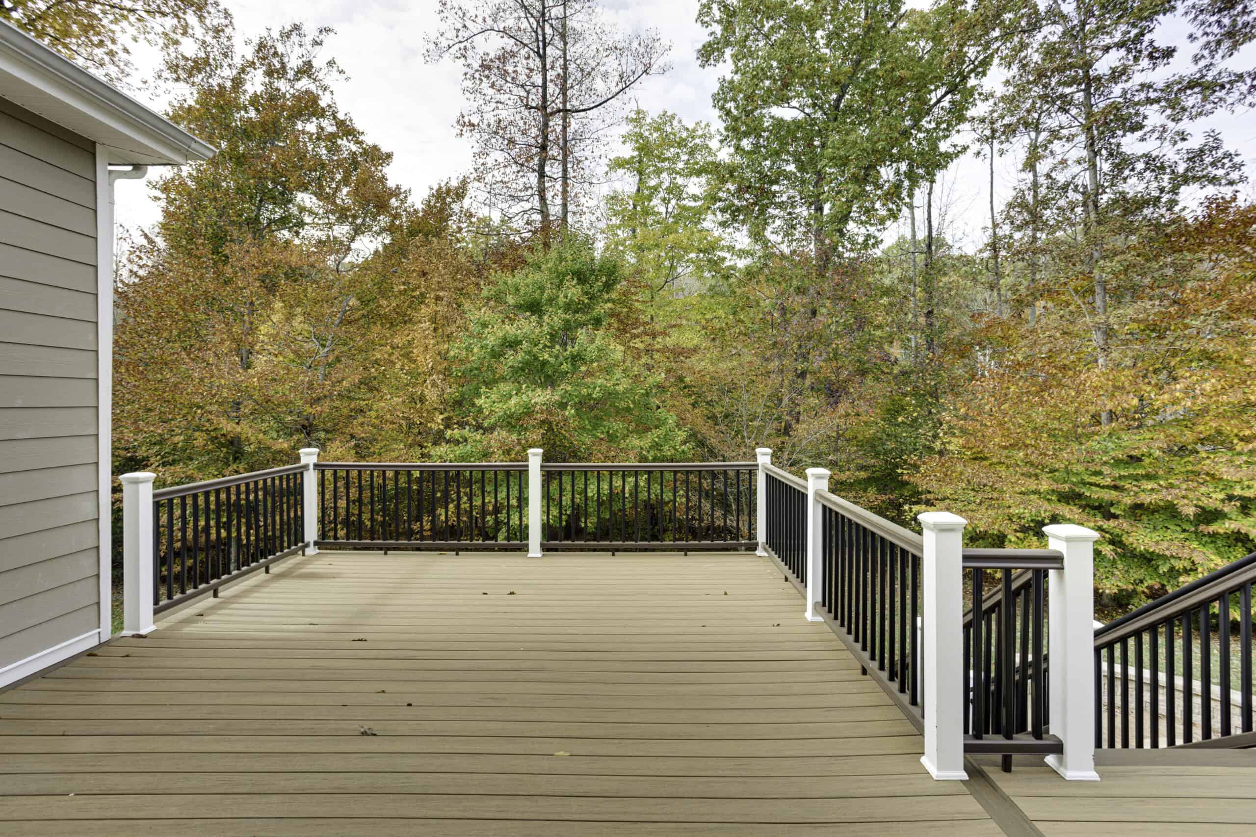 Deck attached to a house with the framing and structural supports visible